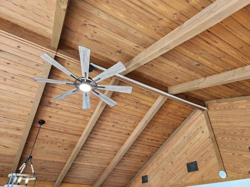 A new ceiling fan installed in a wood ceiling using wire mold.