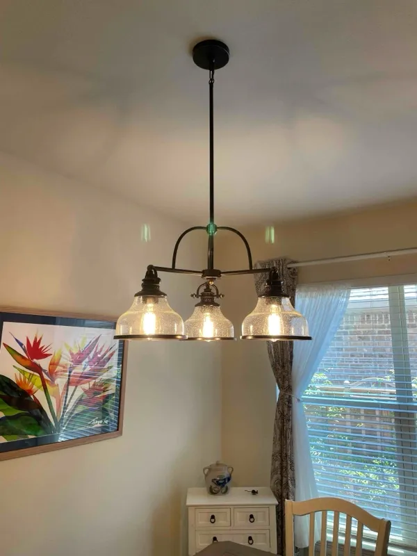 A light fixture installed above a dining table.