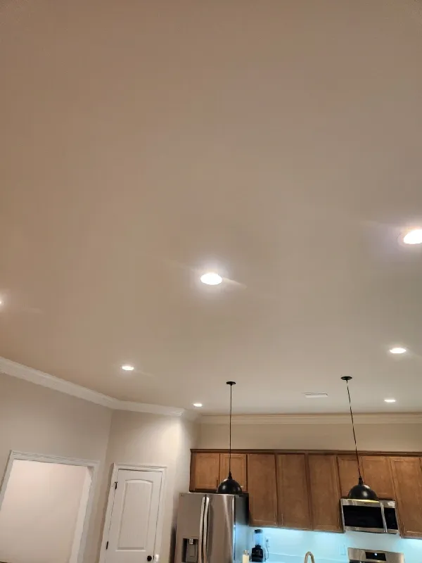 Recessed lighting installed in the kitchen ceiling.