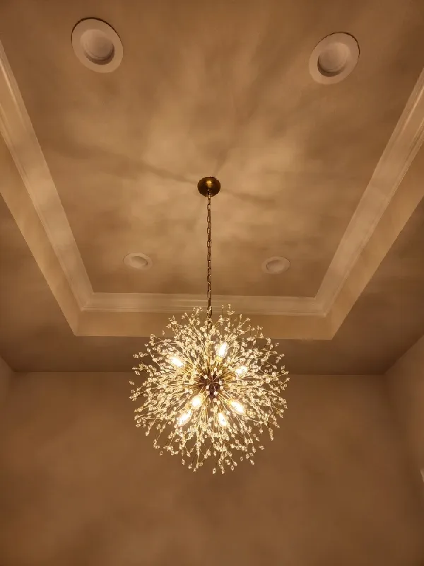 A round light fixture that looks like fire works bursting.