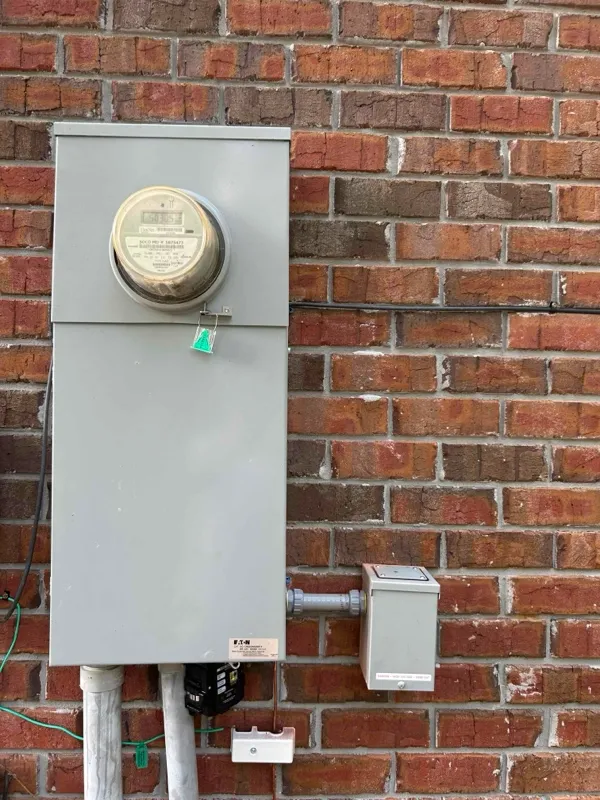 An upgraded main electrical panel with generator inlet for portable generator use.
