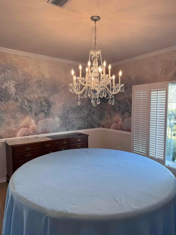 A chandelier installation in a dining room at a home in Beulah, FL.
