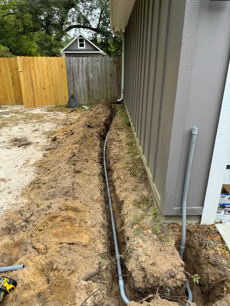 An open trench containing electrical conduit for a dedicated RV circuit.