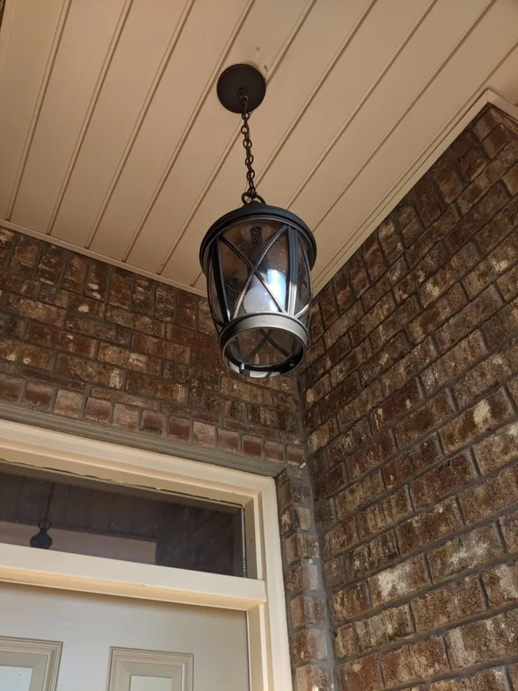 A pendant light installed on a front porch.