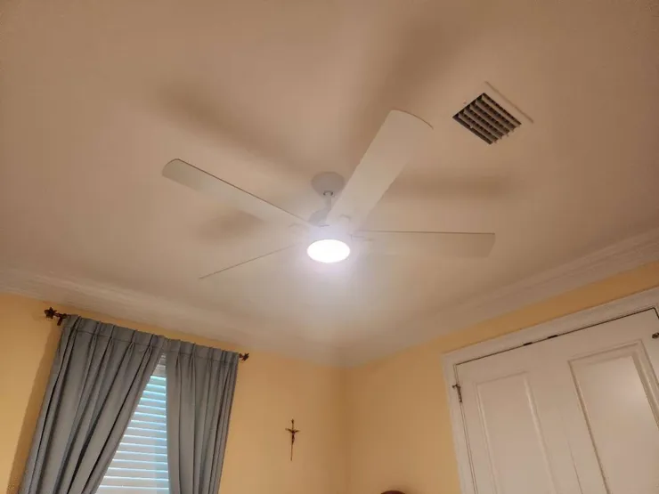 A ceiling fan installation in a bedroom.