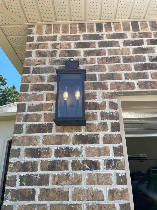 Coach light installed outside of garage roll up door.