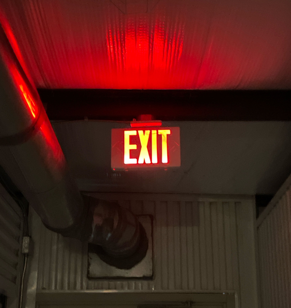Lighted exit sign in a commercial storage building.