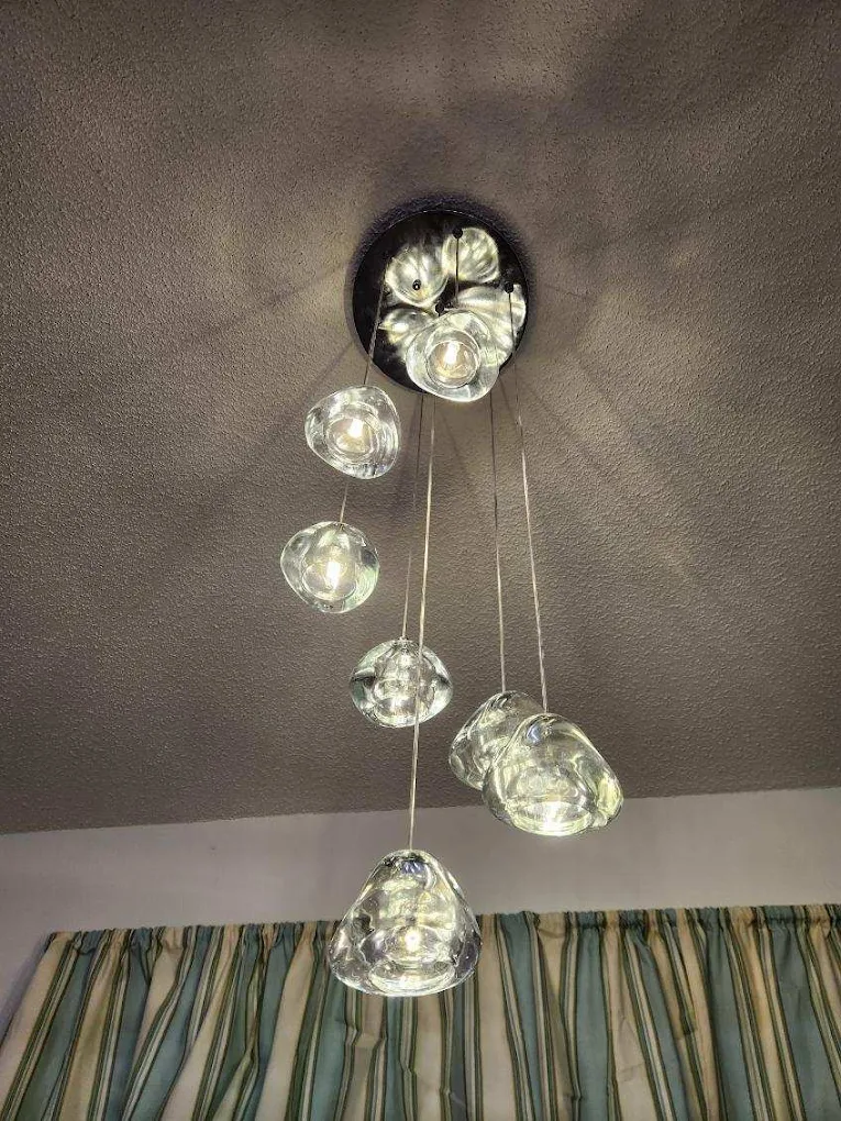 A multi-drop pendant light fixture installed in a home dining nook.