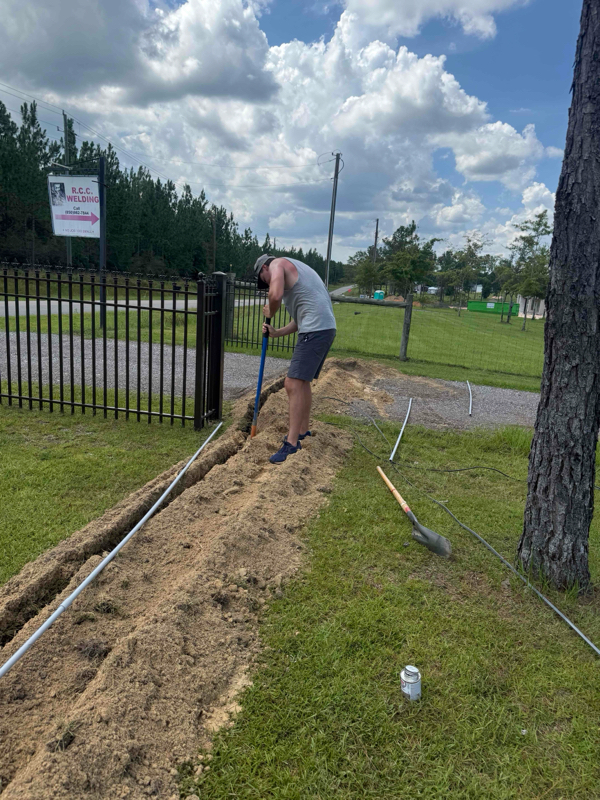Electrician working on trench.