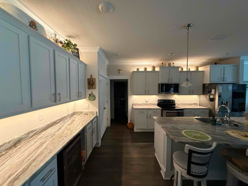 Under cabinet and above cabinet strip lighting in kitchen.