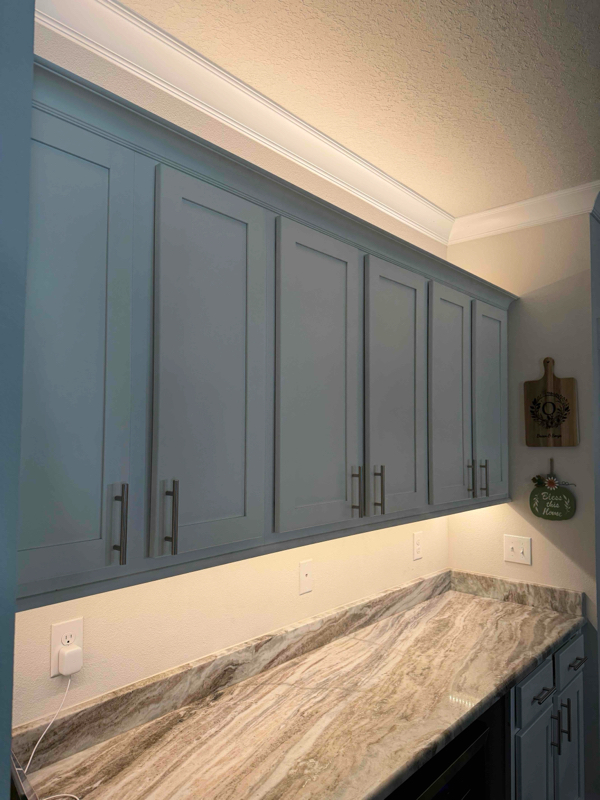 Under cabinet and above cabinet strip lighting in kitchen.