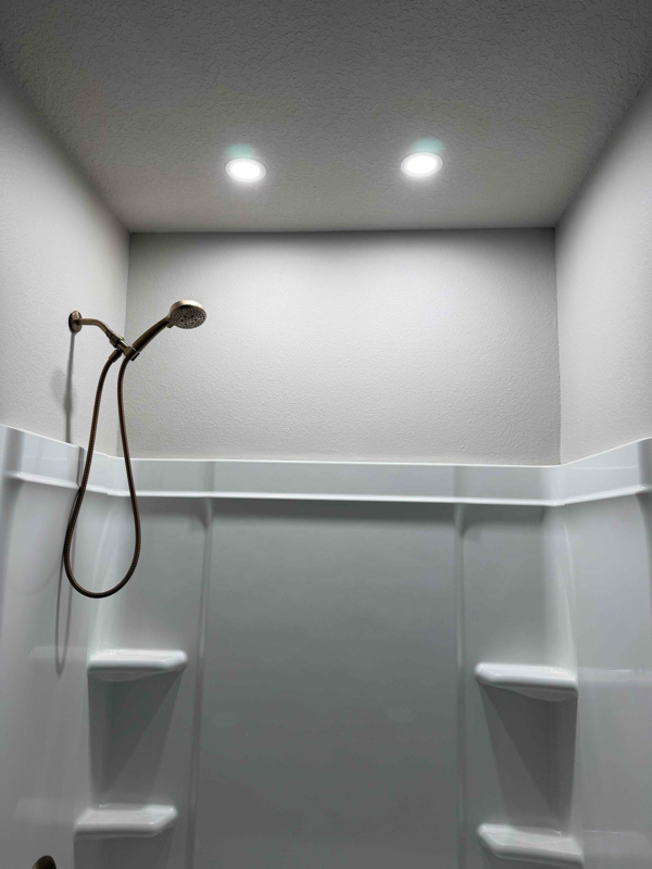 Wafer lighting above shower.